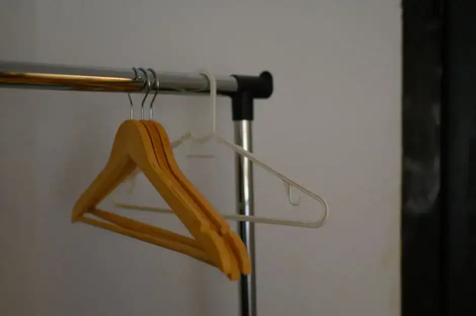 Slim hangers holding shirts on a closet rod