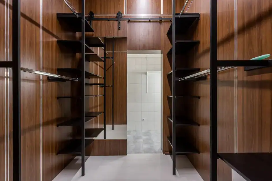 Vertical closet shelving stacked with shoes and bags