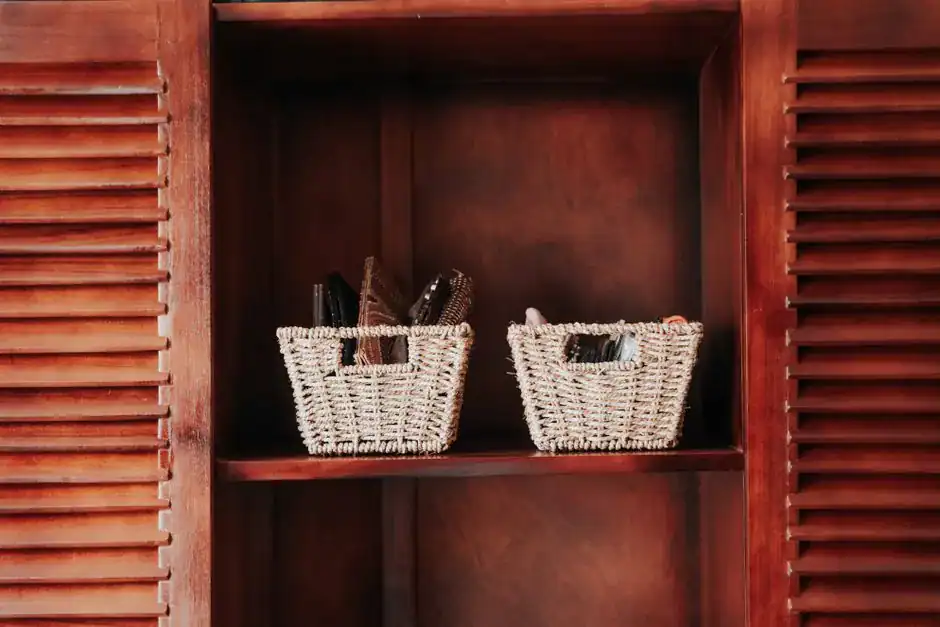 Woven baskets used for storage on a shelf