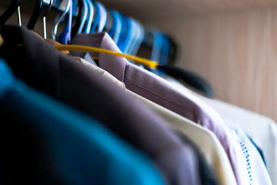 Shirts hanging neatly on a closet rod
