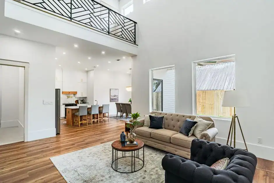 A bright, updated living room with layered seating and a loft