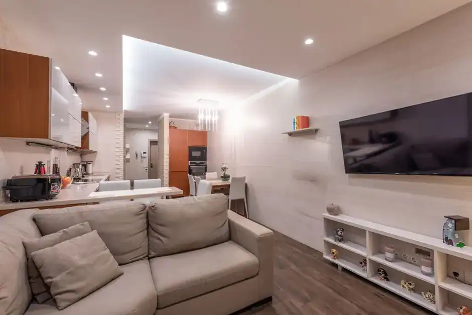 A functional living room with built-in storage and a media wall