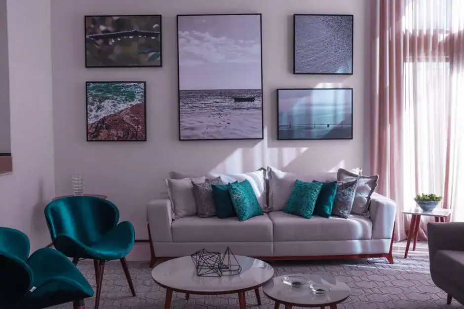 A living-room gallery wall of framed art above the sofa
