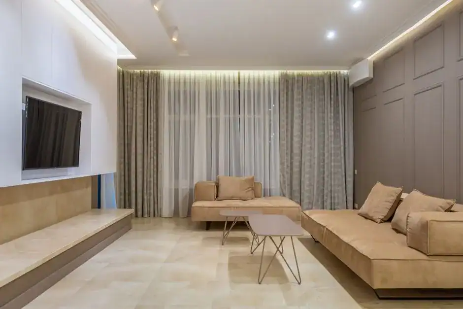A living room in a soft, neutral color palette