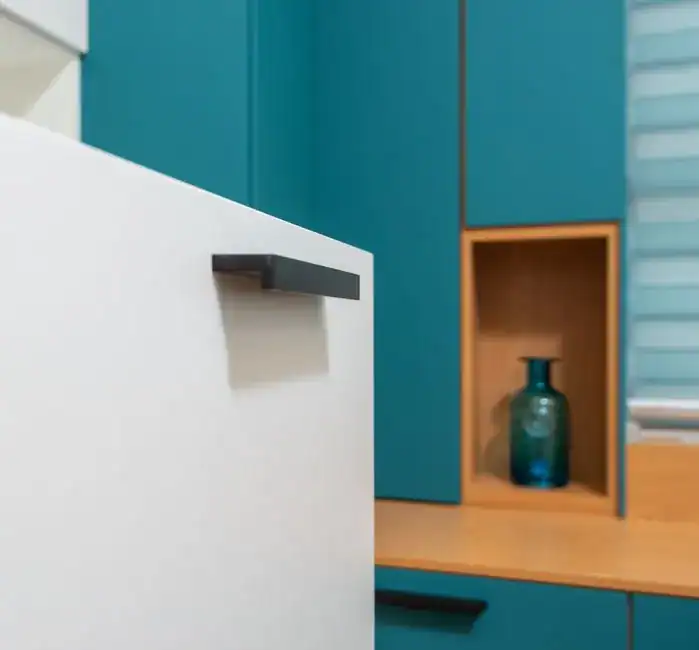 A sleek, modern handle on a cabinet drawer