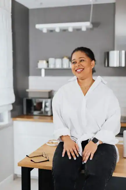 A confident woman smiling at home
