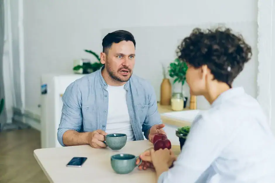 A couple talking thoughtfully over coffee