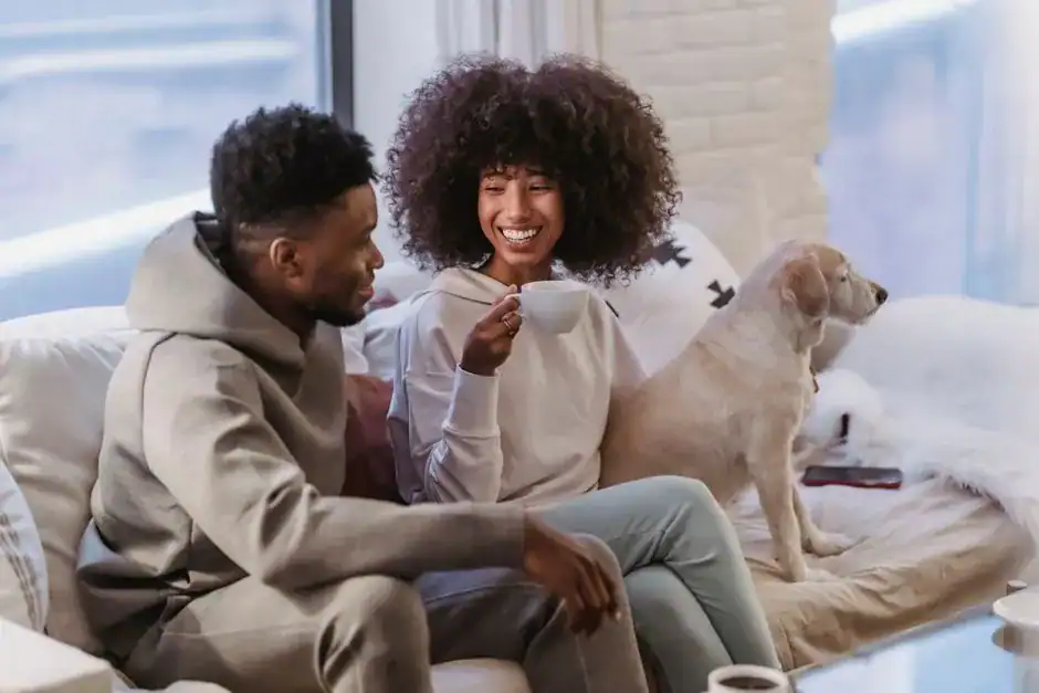 A relaxed couple talking on the couch at home