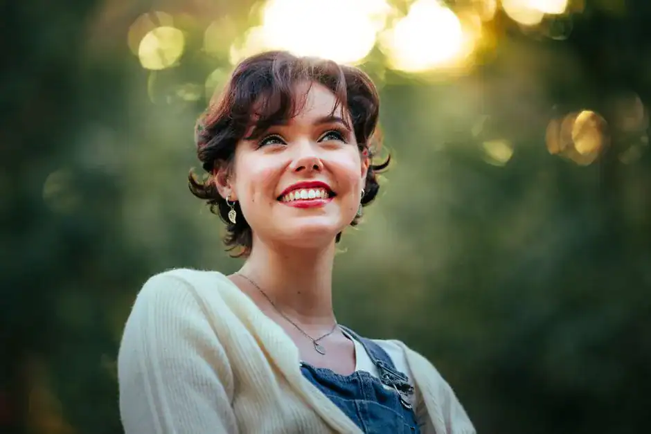 A cheerful woman smiling in the sunlight