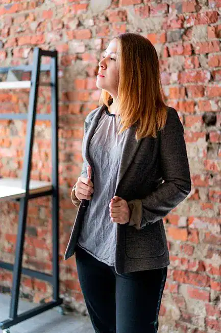 A confident woman standing tall in a blazer