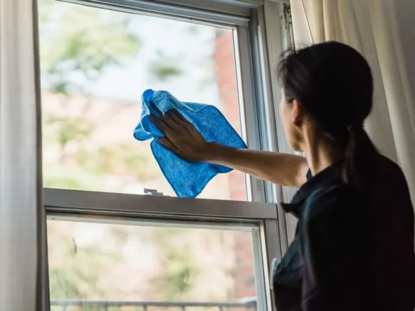 Wiping a window clean with a microfiber cloth