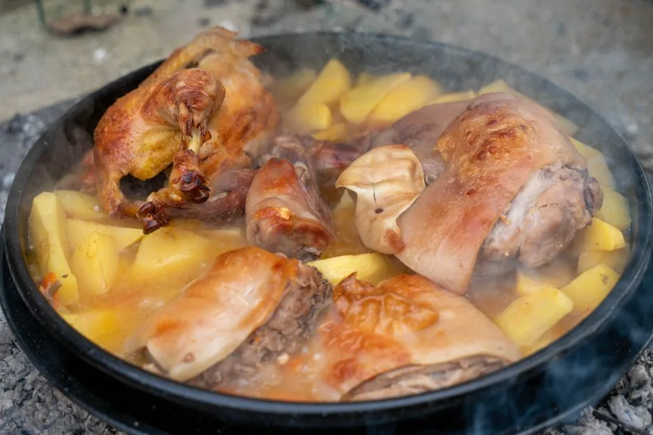 Braised meat and potatoes cooking slowly in a heavy pot