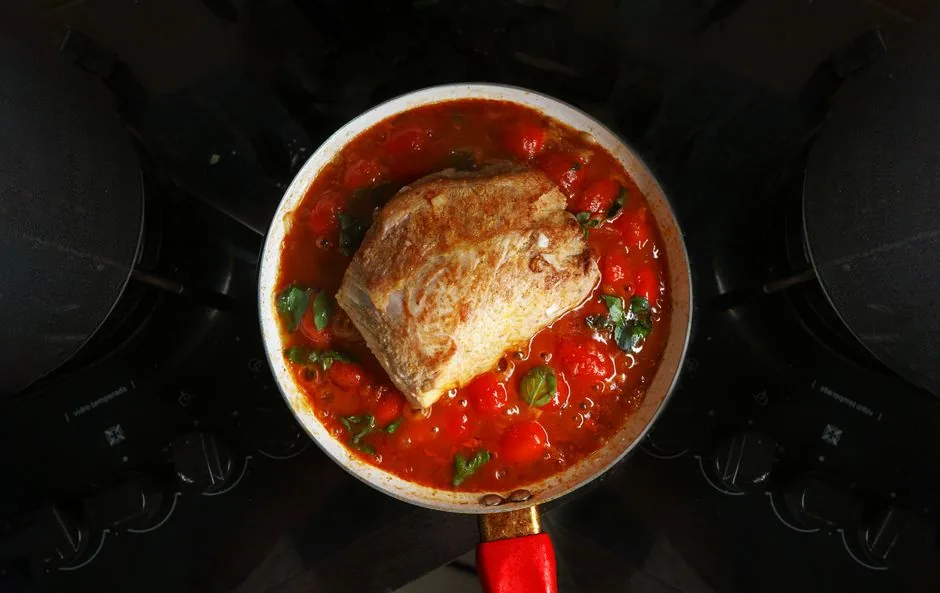 Tomato sauce simmering in a pan on the stove