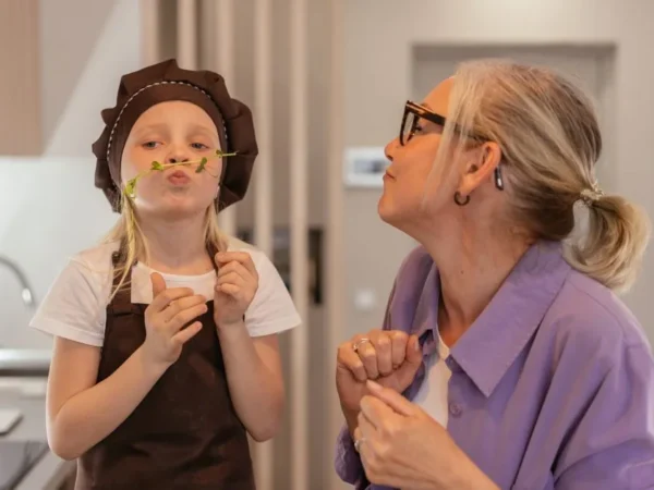 A grandmother and her granddaughter cooking together in the kitchen