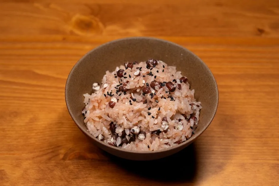 A simple bowl of rice and beans on a wooden table