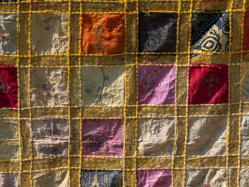A handmade patchwork quilt pieced from scraps of old fabric