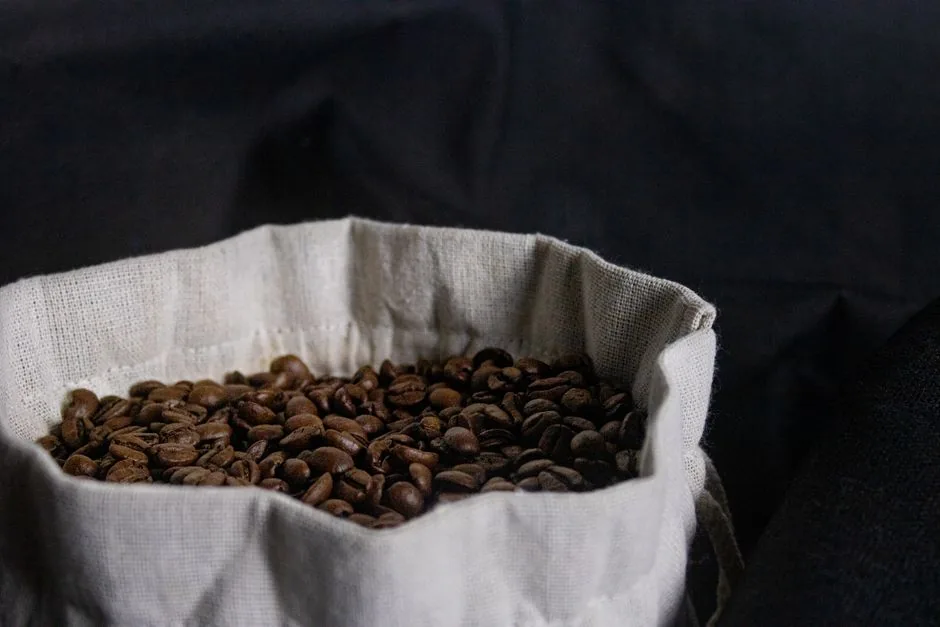 Whole coffee beans in a cloth bag