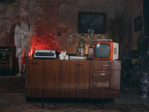 A retro living room with a vintage television on a mid century credenza