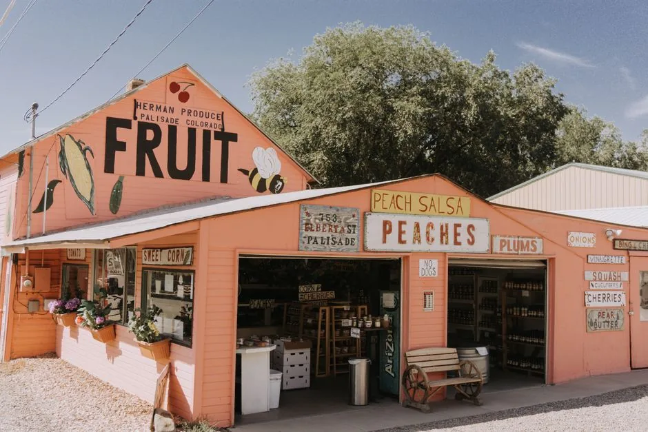 A roadside produce stand selling peaches and local fruit