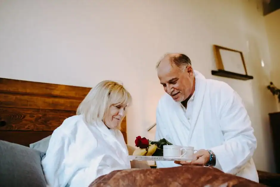 Senior couple sharing a loving breakfast in bed, exuding warmth and togetherness.