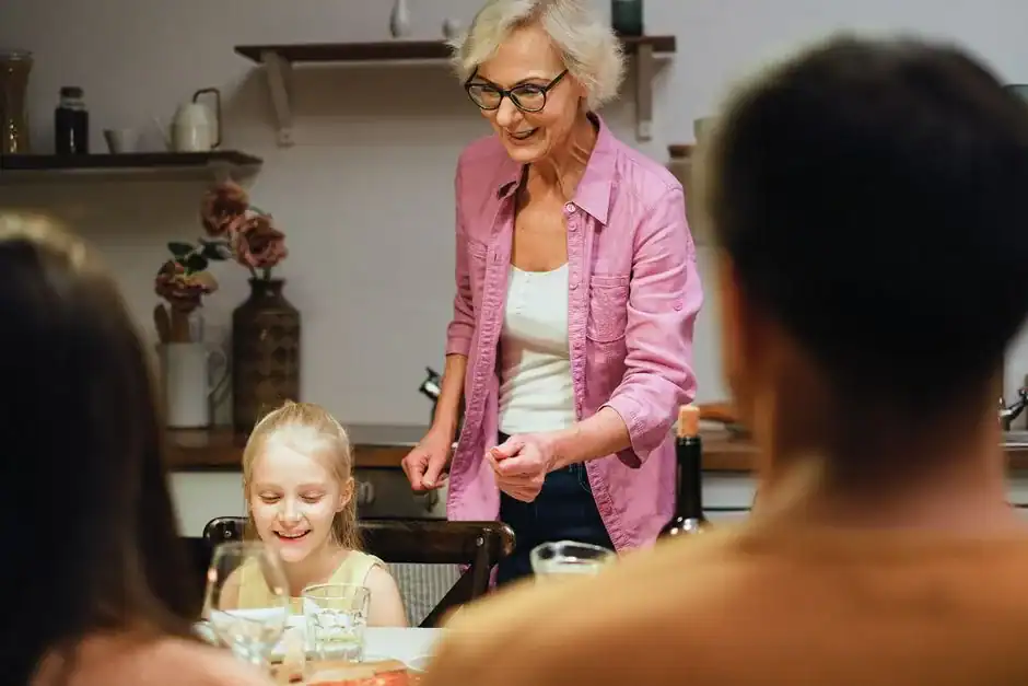 A joyful family gathering around the dinner table, showcasing togetherness and warmth indoors.