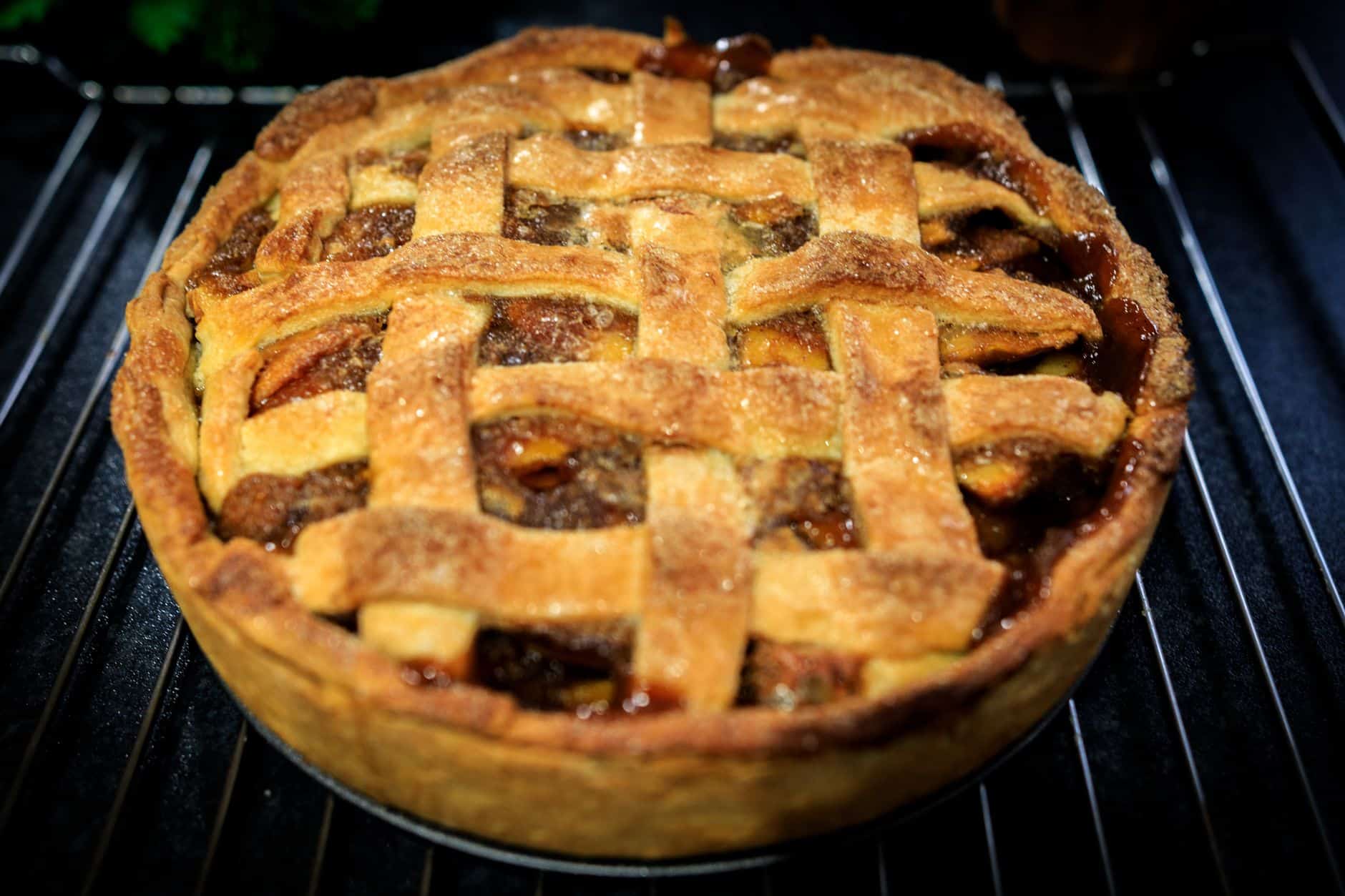 Homemade apple pie with a golden lattice crust in a pie dish