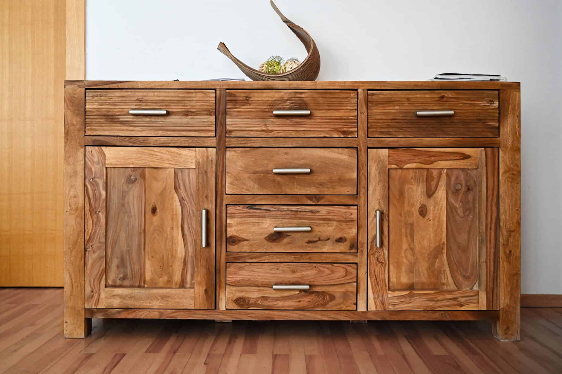 Solid wood dresser with drawers and cabinet doors showing the natural grain