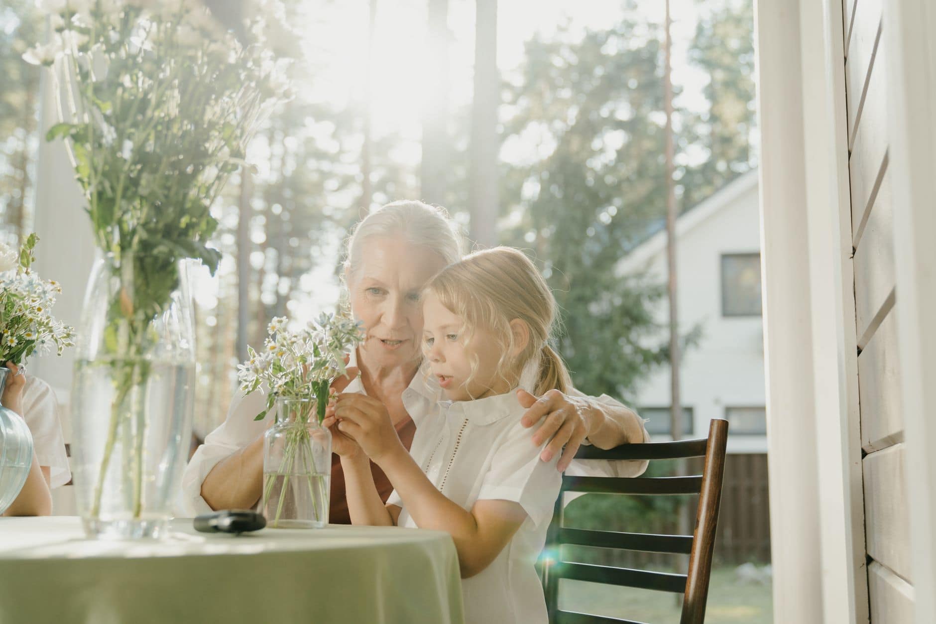 Grandmother and granddaughter together on a sunny porch