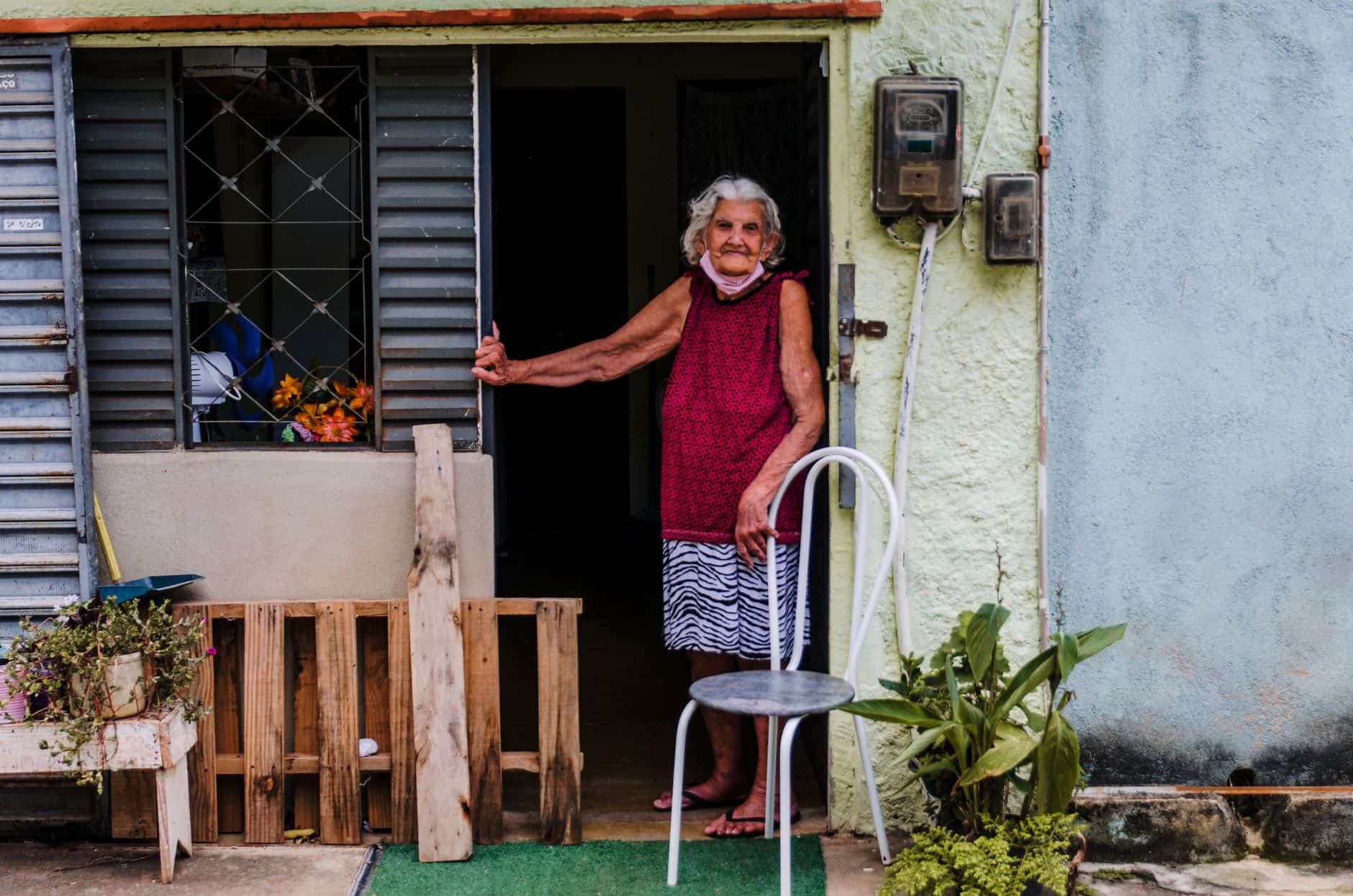 Grandmother smiling in the doorway of her home