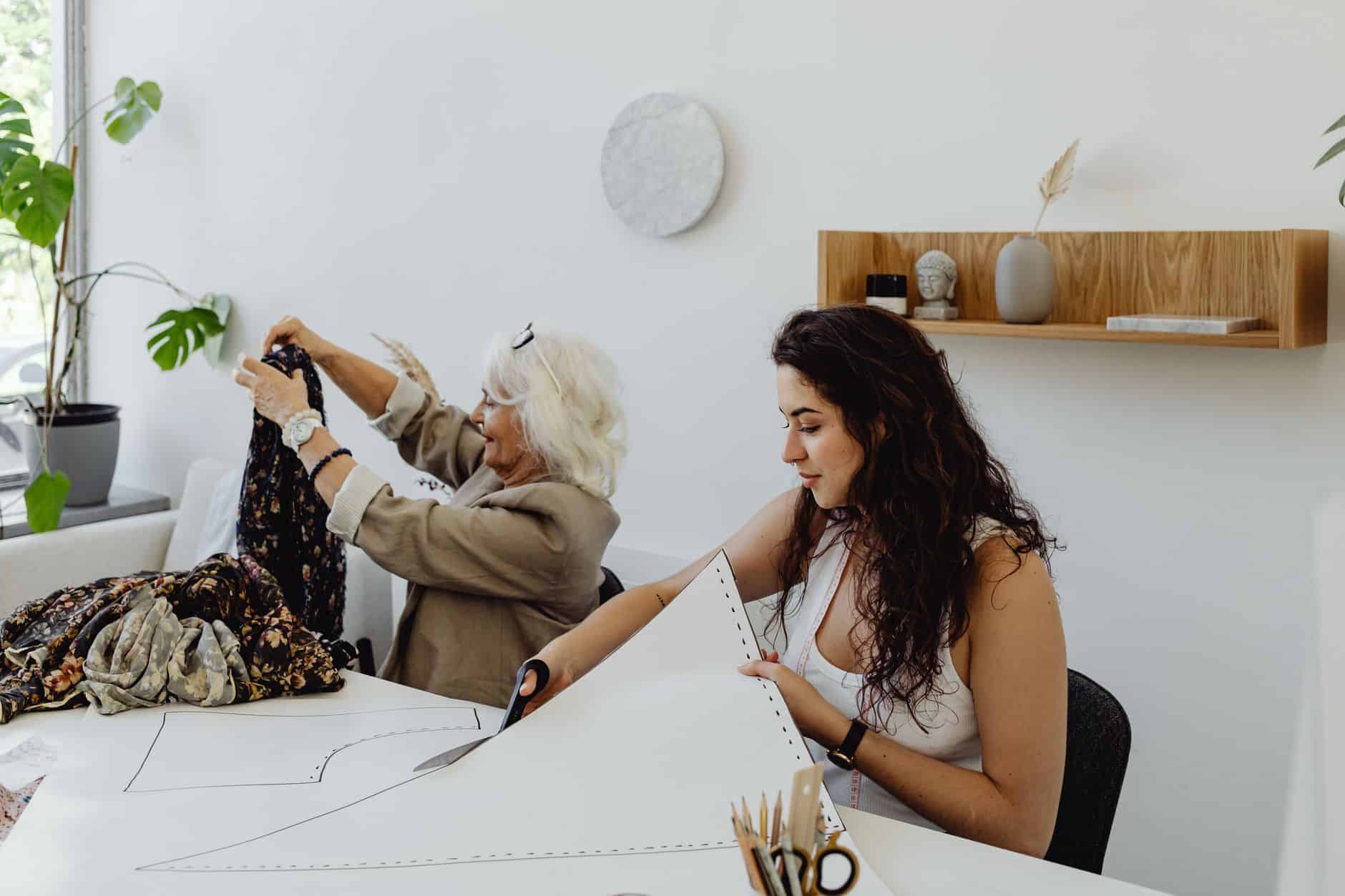 Grandmother sorting fabric with a younger woman