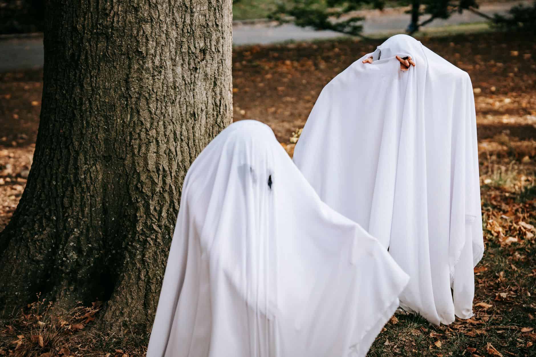 Children dressed as ghosts in homemade white sheet costumes